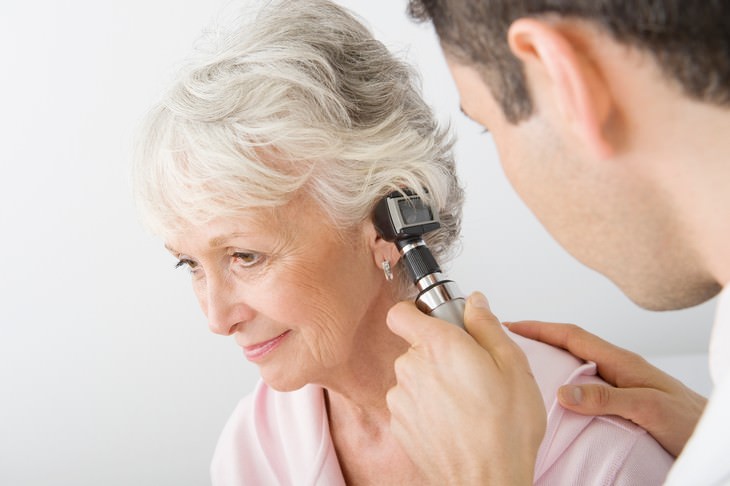 9 Conditions You Think Are Contagious But Aren't, senior woman getting checked for ear infections