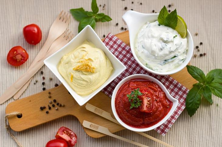 8 tips and tricks to help children develop healthy eating habits, Three bowls of dips, red, yellow and white, on a table