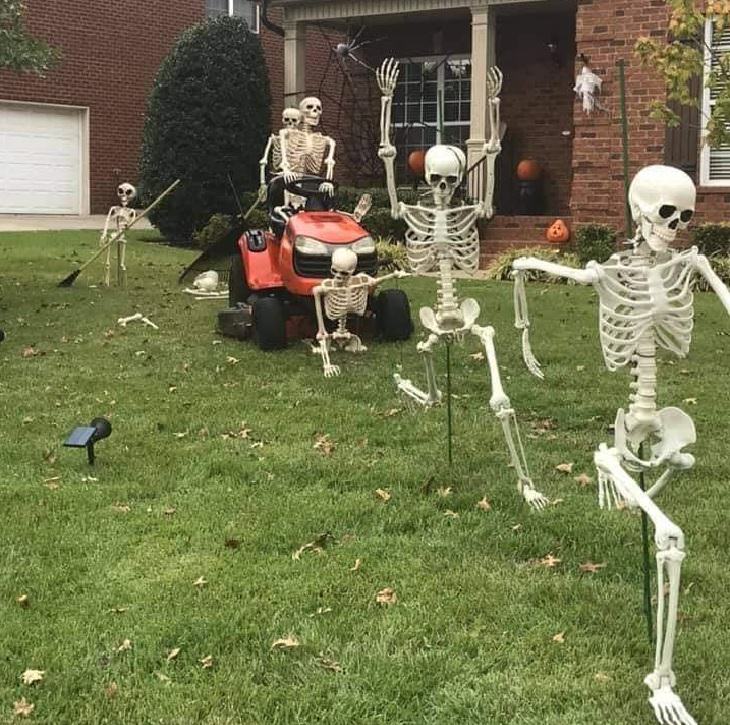 Creative and spooky halloween decorations from 2020, Skeleton driving lawn mower chasing other skeletons