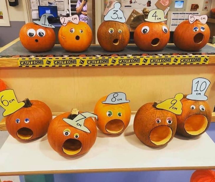 Creative and spooky halloween decorations from 2020, Pumpkins carved with “Oh” faces of different sizes at OBGYN clinic