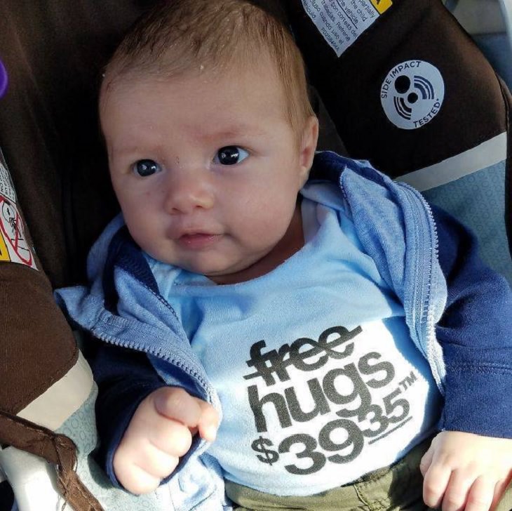 Clever and funny dads that win at parenting, Baby wearing t-shirt that says “Free Hugs $39.95”