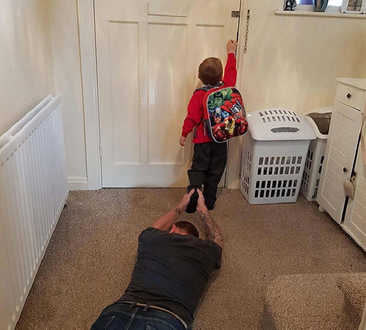 Clever and funny dads that win at parenting, Father clinging to young son’s leg as he leaves for school