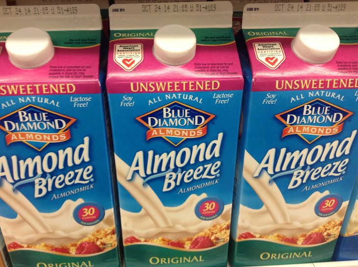 Common ingredients to be avoided in weight-loss smoothies, Cartons of unsweetened almond milk lined up in a grocery store