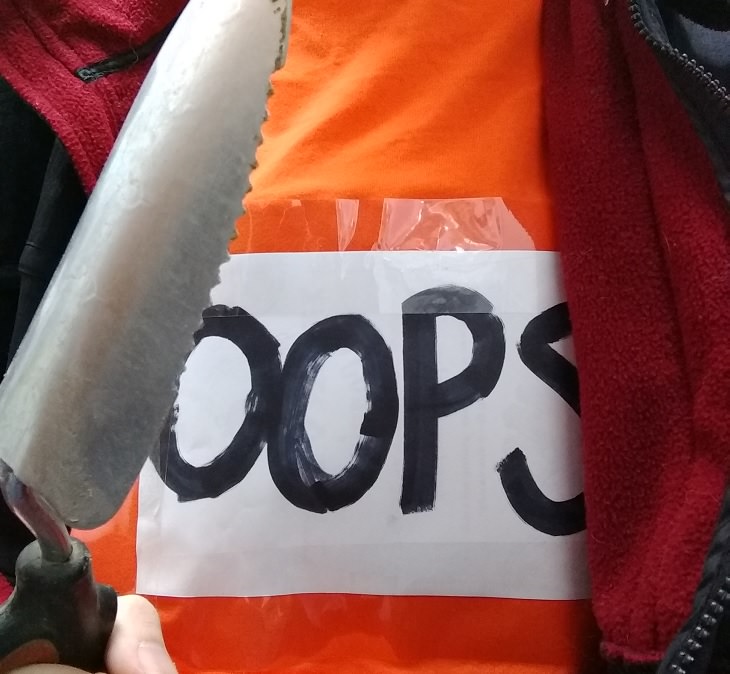 Hilarious and clever Halloween costumes based on puns and word play, Man in a t-shirt that says “Oops” holding a trowel