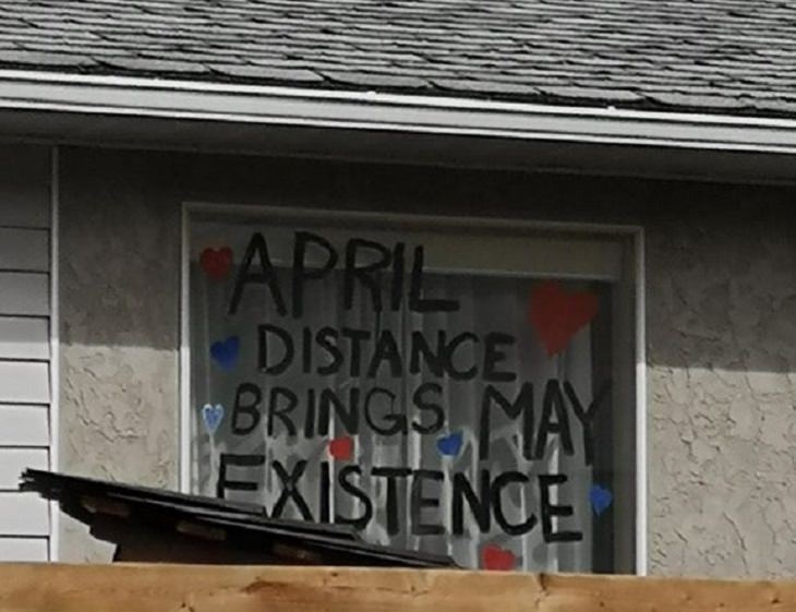 Funny signs related to the quarantine and lockdown caused by the COVID-19 (coronavirus) pandemic, writing on window in black that says “April distance brings May existence”