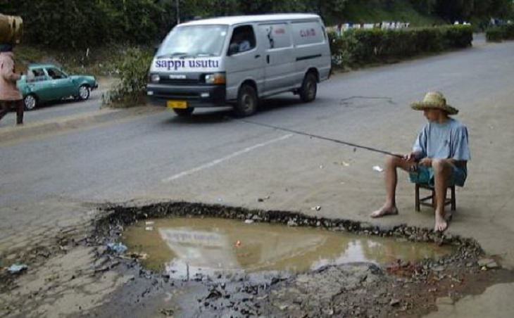 Hilarious photos showing things that can happen only in Africa, Man fishing in a flooded pothole