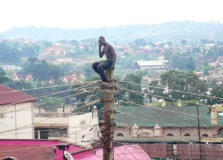 Hilarious photos showing things that can happen only in Africa, Man sitting on the top of a telephone pole