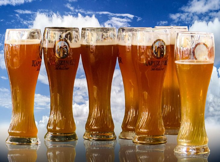 Downsizing and labelling marketing ploys done to trick Customers by big companies, Group of long tall beer glasses