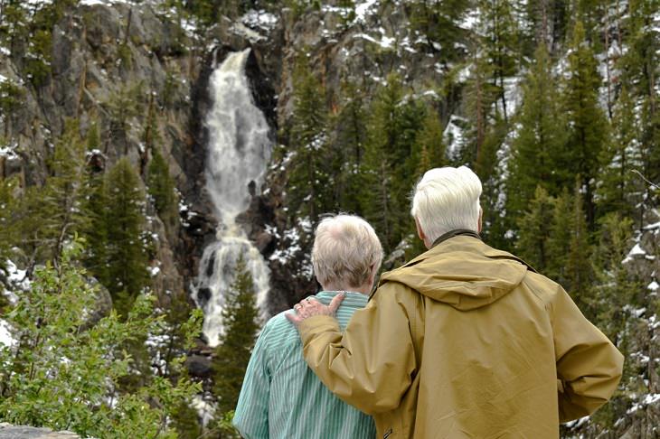 Incredible things done by seniors, Old man and woman from behind looking at the Rocky Mountains