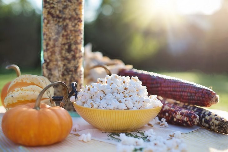 Healthy foods you can enjoy as late-night snacks if you get midnight cravings, Bowl of popcorn on a table with corn
