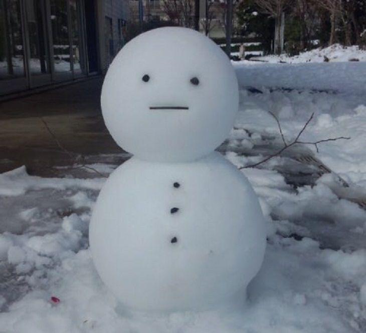 Residents of Tokyo create creative and unique snowmen and ice sculptures, A traditional Japanese snow man called Yuki Daruma with a straight face