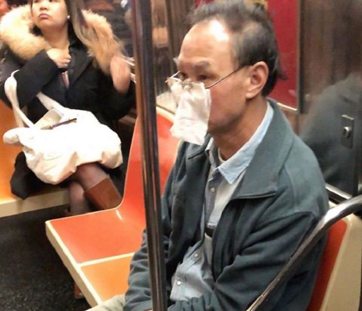 Hilarious photos of strange masks spotted on the subway, Man with a napkin tucked into his glasses covering his mouth and nose