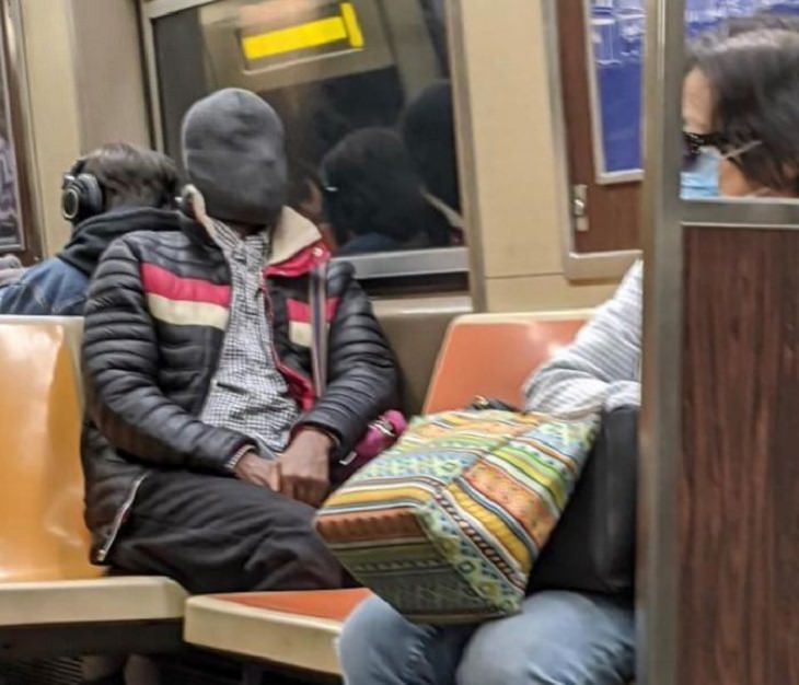 Hilarious photos of strange masks spotted on the subway, Man wearing full black ski-mask sitting on subway
