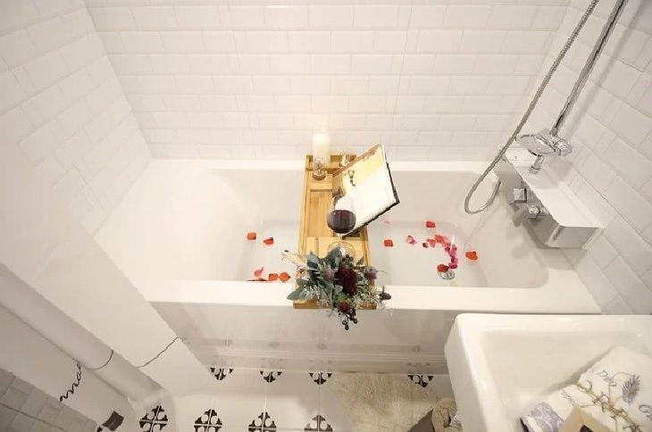 Household uses for old and used teabags, Filled bathtub with rose petals and stand for reading