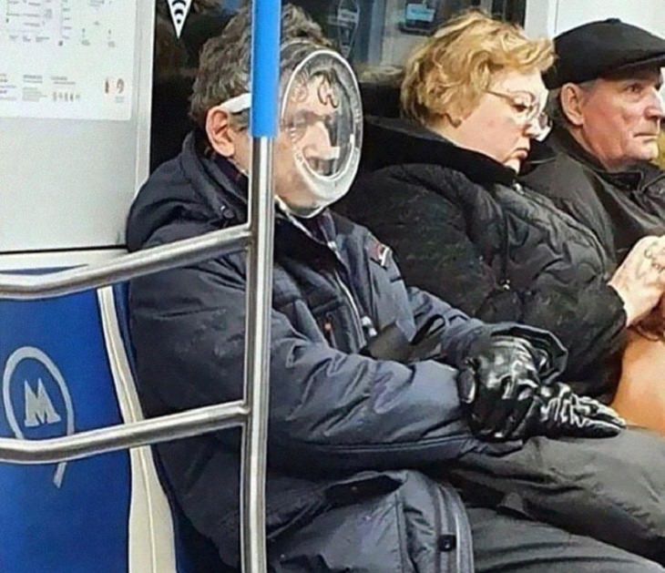 Hilarious photos of strange masks spotted on the subway, Man sitting on the subway wearing a plastic box as a mask