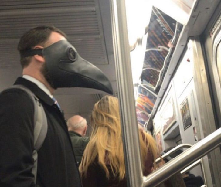 Hilarious photos of strange masks spotted on the subway, Man wearing a crow mask on the subway