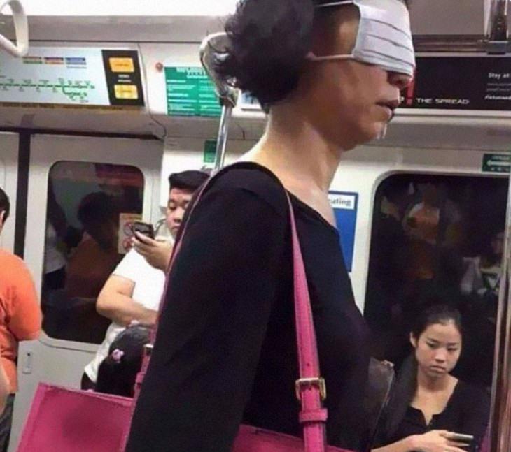 Hilarious photos of strange masks spotted on the subway, Woman wearing a mask across her eyes