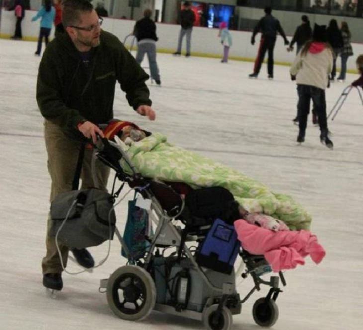 Photos of feel good stories that will make you smile, Father ice skating with sick daughter in an adjusted wheelchair