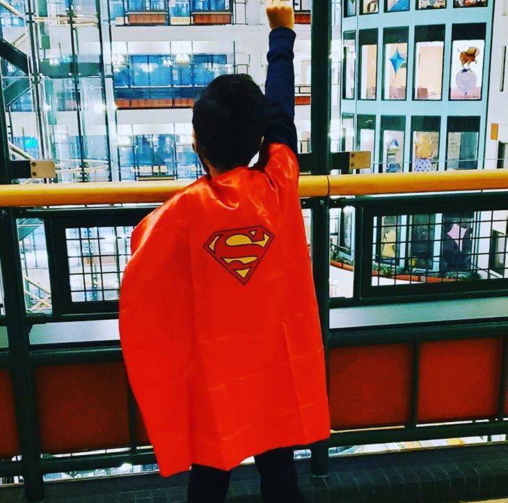Photos of feel good stories that will make you smile, Kid in a superman cape with fist in the air victoriously