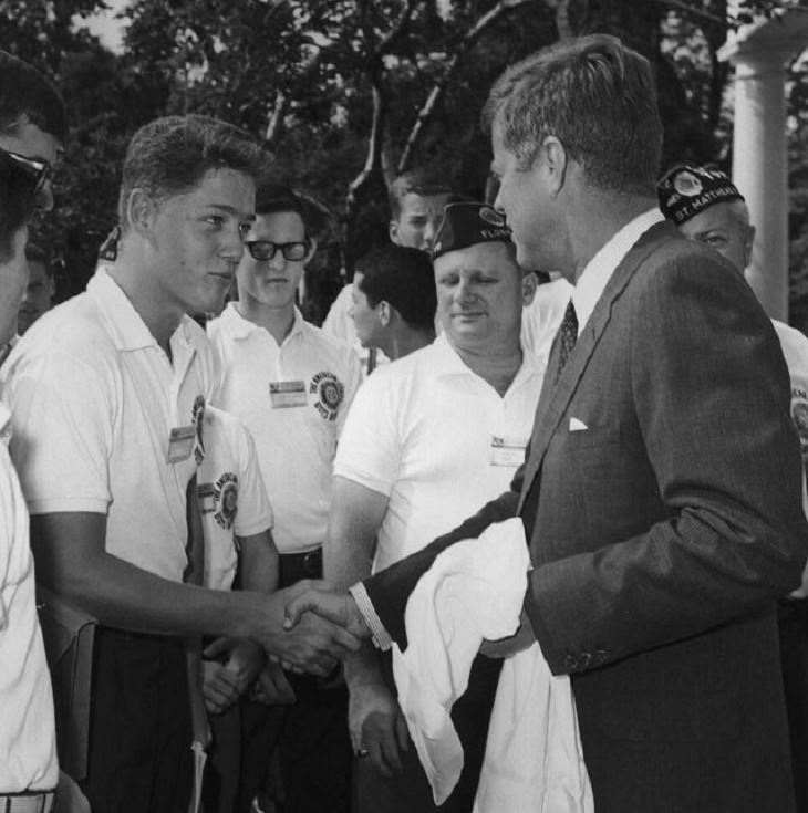 Historical photographs, President John F. Kennedy shakes the hand of a teenage Bill Clinton