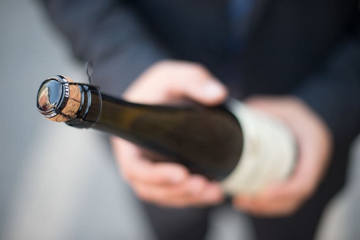 5 old rules of etiquette that we need to keep alive, Person holding a wine bottle