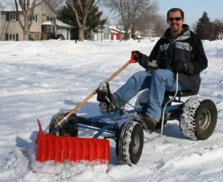 Makeshift, unique, and creative snowplows, lawnmower with shoveled attached to the front