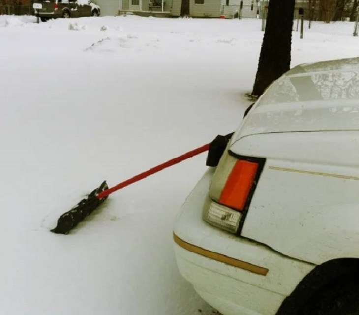 Makeshift, unique, and creative snowplows, car with shovel attached to the front