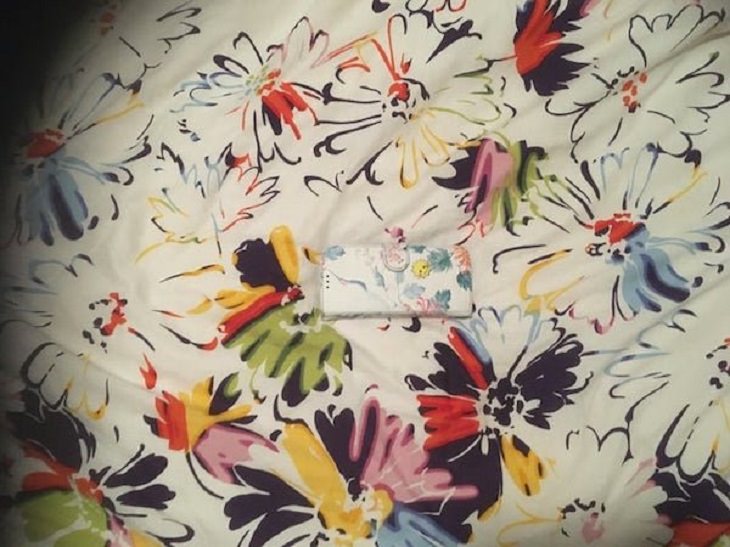 Funny pictures of household items, animals, and people that camouflaged, Phone with flowered cover on a flowered bedsheet