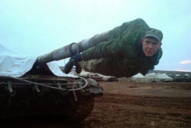 Strange, odd and weird things only found in Russia, man hanging from a cannon tank