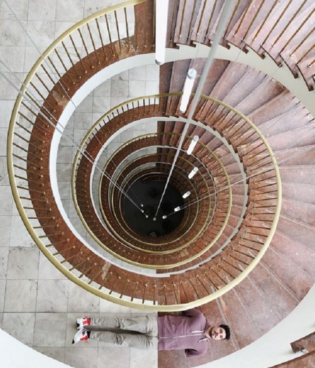 Incredible optical illusions created by Artist and photographer from Portugal Tiago Silva, man in brown and white blends into brown and white spiral staircase