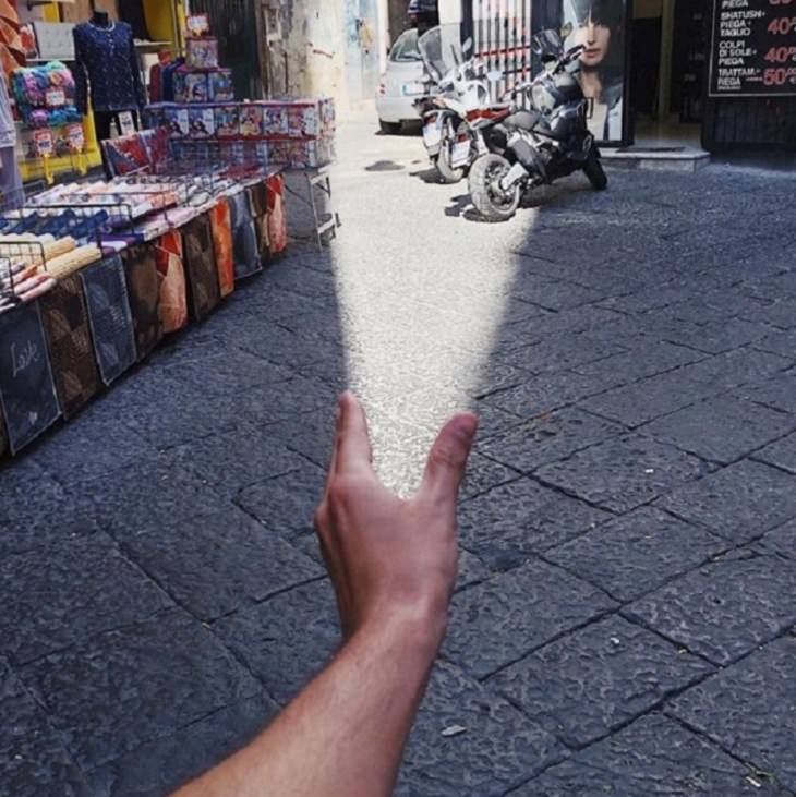 Incredible optical illusions created by Artist and photographer from Portugal Tiago Silva, a beam of light onto a street from a hand