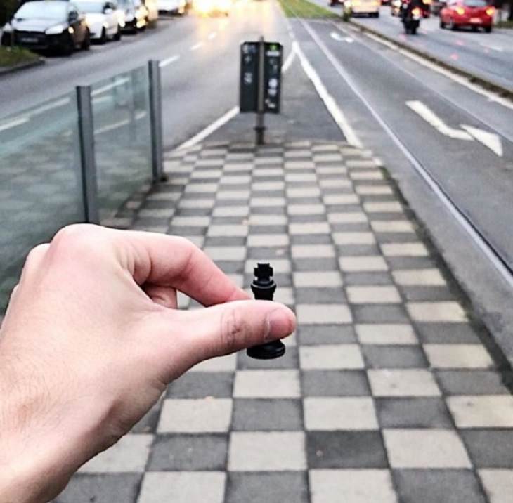 Incredible optical illusions created by Artist and photographer from Portugal Tiago Silva, road resembling chess board with a pawn held on to it