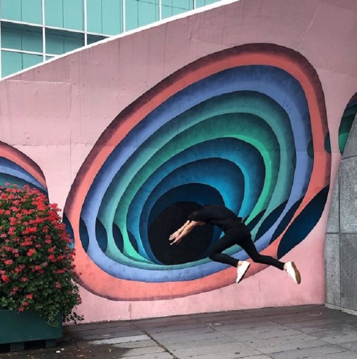 Incredible optical illusions created by Artist and photographer from Portugal Tiago Silva, man diving in to painted spiral hole in the wall
