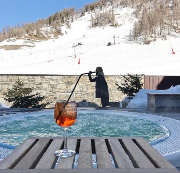 Incredible optical illusions created by Artist and photographer from Portugal Tiago Silva, drinking from a straw that seems to stretch across the pool