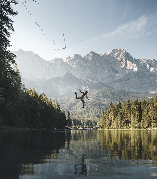 Winners of the Nature Conservancy World wide Photo Competition / Contest, People in Nature, Honorable Mention: Anskar Lenzen, Germany REFRESHMENT: A visitor jumps into the iconic lake Eibsee on a sultry summer day in southern Germany