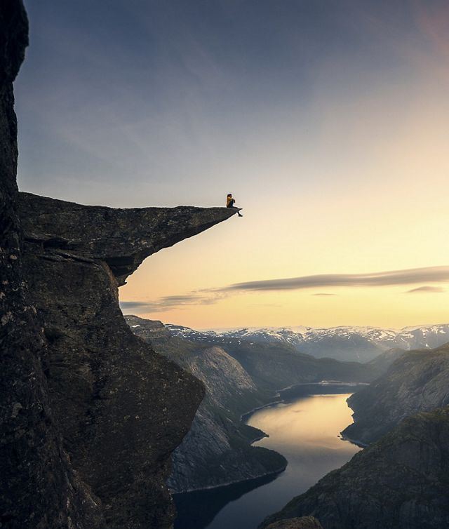 Winners of the Nature Conservancy World wide Photo Competition / Contest, Landscapes, Third Place: Guilherme Gomes de Mesquita, Brazil ON THE BRINK: A hiker sits at the edge of a cliff in Trolltunga, Norway