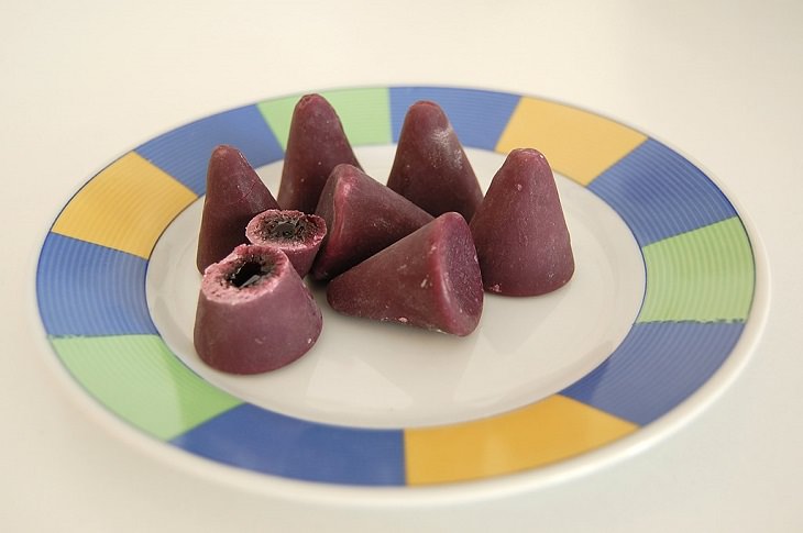 candies, sweets, chocolates and confectioneries from around the world with unique flavors and ingredients, Cuberdon, a cone-shaped chocolate from Belgium with a crispy outer crust and a melted chocolate core, usually raspberry flavored