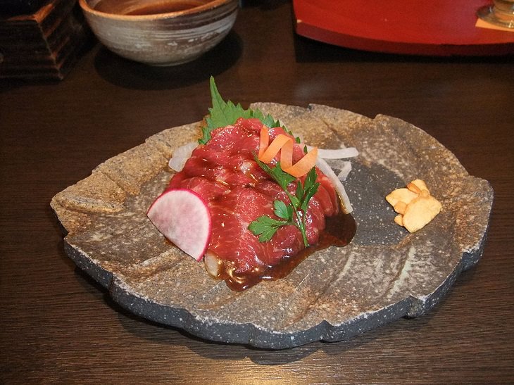 Strange, weird, odd and unusual foods, recipes and ingredients from different countries around the world, Basashi, raw sliced horse meat served in Japan either on its own or as a part of sushi
