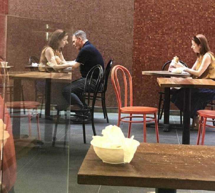 Photographs and pictures of interesting natural phenomenon or well-timed moments that will make you look twice, woman's reflection giving the appearance of her sitting with a man