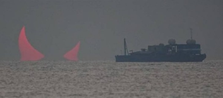 Photographs and pictures of interesting natural phenomenon or well-timed moments that will make you look twice, ship sails towards two sail boats that look like devil horns
