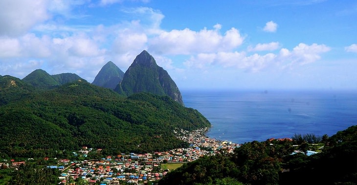 Beaches, festivals, cultural celebrations, world heritage sites, mountains, nature and wildlife, and other must see sights in Saint Lucia, windward islands, caribbean sea, The twin peaks The Pitons, standing behind the town Soufrière