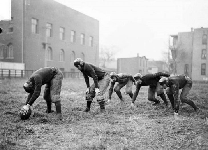 Incredible moments in historical captured on camera, important historical photographs, Players of a Chicago High school football team practicing in 1902