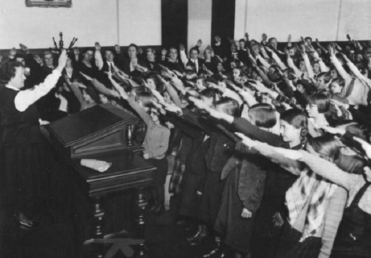 Incredible moments in historical captured on camera, important historical photographs, At an elementary school in Berlin, students are made to pay tribute to the then Nazi-leader Adolf Hitler, in 1934