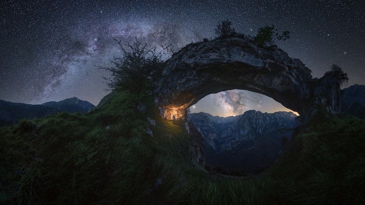 Best and colorful photographs of the Milky Way taken from different locations around the world, provided by Capture the Atlas editor Dan Zafra, “Double Arch” by Pablo Ruiz García, in “La Hermida” gorge in the Picos de Europa, Spain
