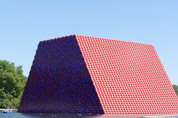 The incredible unique and monumental works of of wrapped art by Christo and Jeanne Claude, a tribute to Artist Christo who died 1st June, 2020, The London Mastaba, in the waters of Serpentine Lake in Hyde Park, installed in 2018