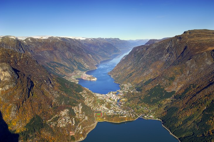 Sights from the popular hiking trail to the rock formation and cliff Trolltunga, near the town of Odda in Norway, An aerial view of the beautiful town of Odda