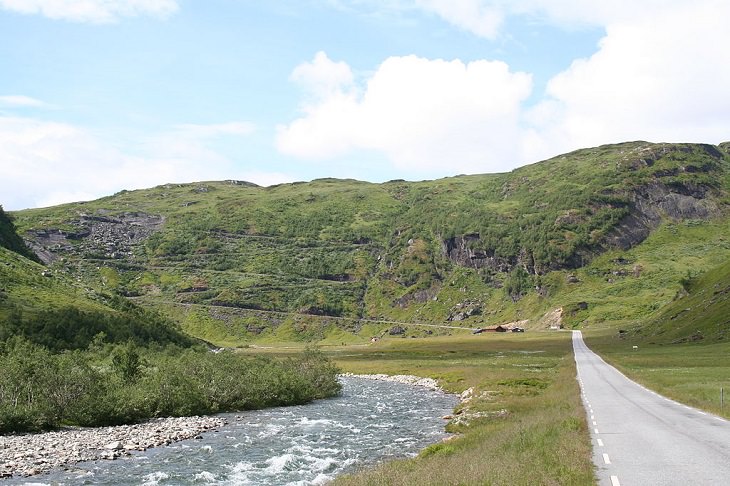 Sights from the popular hiking trail to the rock formation and cliff Trolltunga, near the town of Odda in Norway, Driving on the Norwegian National Road 13, alongside a stream, to reach the trailhead for Trolltunga