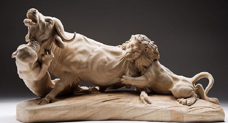 Realistic Animal Sculptures carved out of wood by woodworking Italian artist Guiseppe Rumerio, lions attacking bison