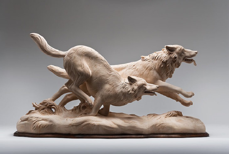 Realistic Animal Sculptures carved out of wood by woodworking Italian artist Guiseppe Rumerio, wolves running