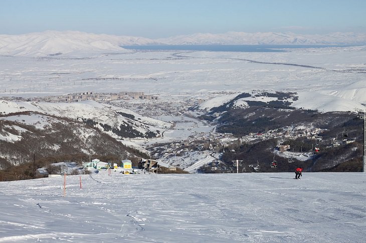 Must-see places in The Caucasus in Europe, Ski run at the Tsakhkadzor ski resort, with Lake Sevan in the background